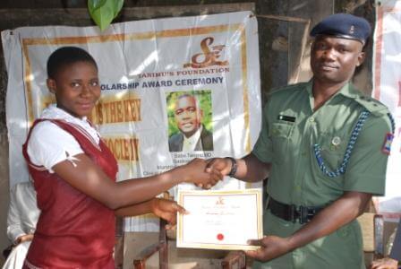 Best student from Tilley Gyado College, Ms. Ageebee Favour Suleiyol receiving her award from Captain M Abdullah, a staff of Nigeria Army School of Military Engineering (NASME), Makurdi, during the 2015 Tanimu foundation award ceremony.