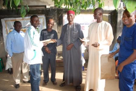 Mr. Maikyau Yusuf Husseini, a 100 level Sociology student from Benue State University, Makurdi receives his award from the Head of the Hausa community, Alhaji Baba Maikyau during the 2015 Tanimu foundation award ceremony at the community level.